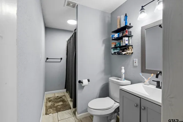 a bathroom with a toilet sink and shower