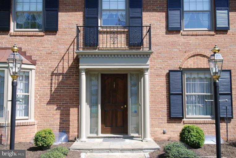 8853 Belmart Road Potomac, MD 20854 - Photo 5 of 8 a view of brick building with a window and a potted plant
