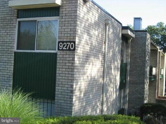 9270 Adelphi Road, Unit 103 Hyattsville, MD 20783 - Photo 1 of 14 a view of a brick building next to a yard