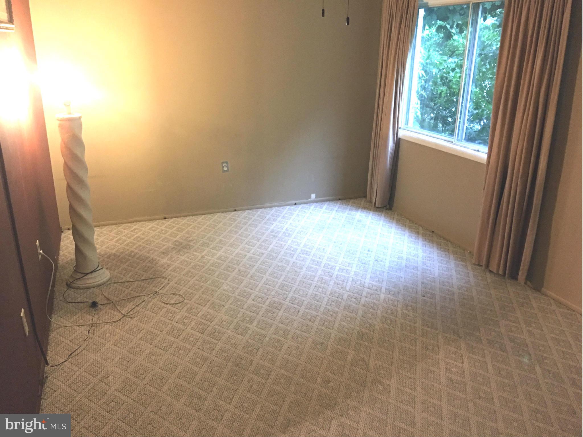 9270 Adelphi Road, Unit 103 Hyattsville, MD 20783 - Photo 13 of 14 a view of empty room with wooden floor and fan