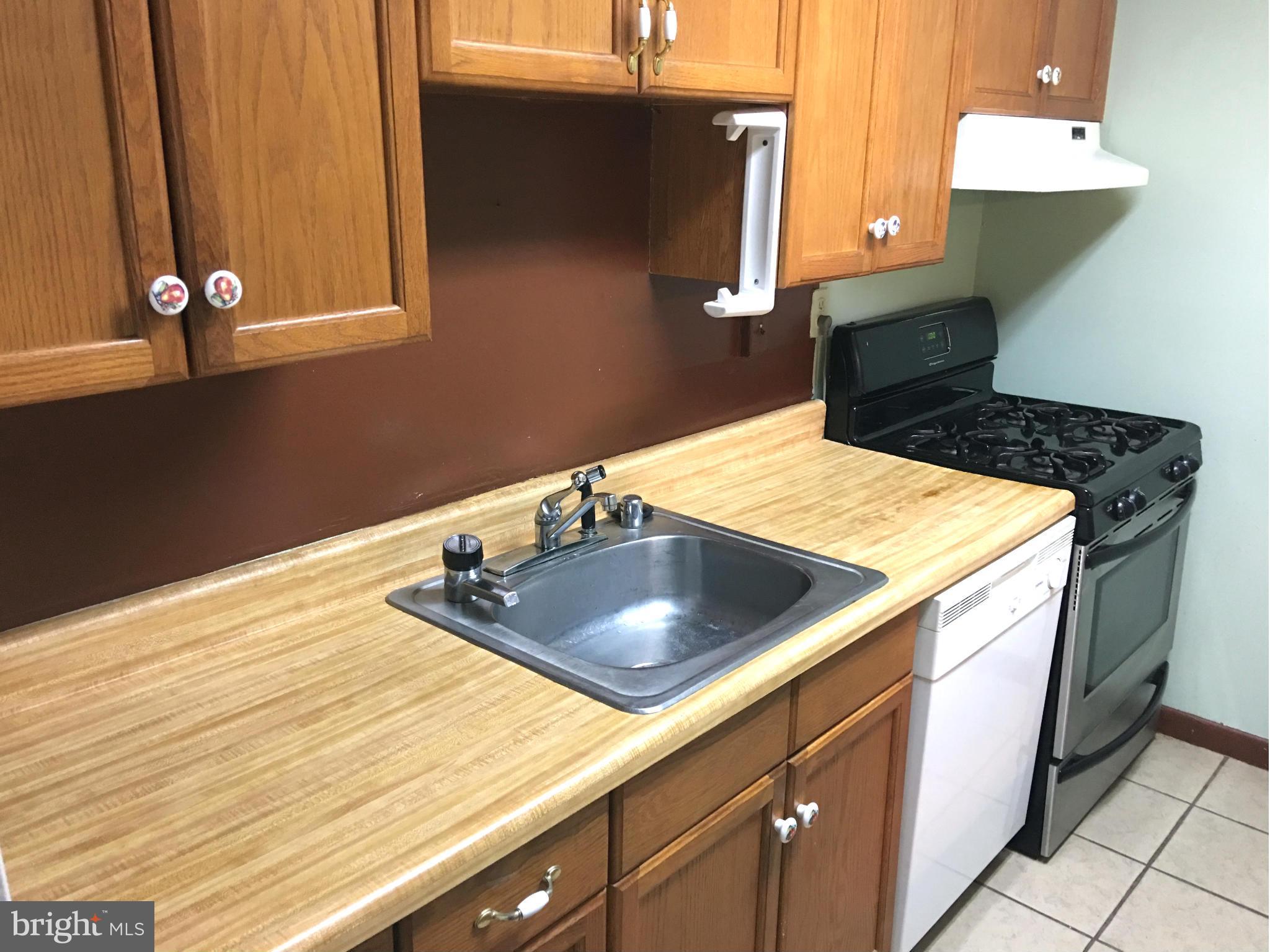 9270 Adelphi Road, Unit 103 Hyattsville, MD 20783 - Photo 8 of 14 a kitchen with a sink and a stove