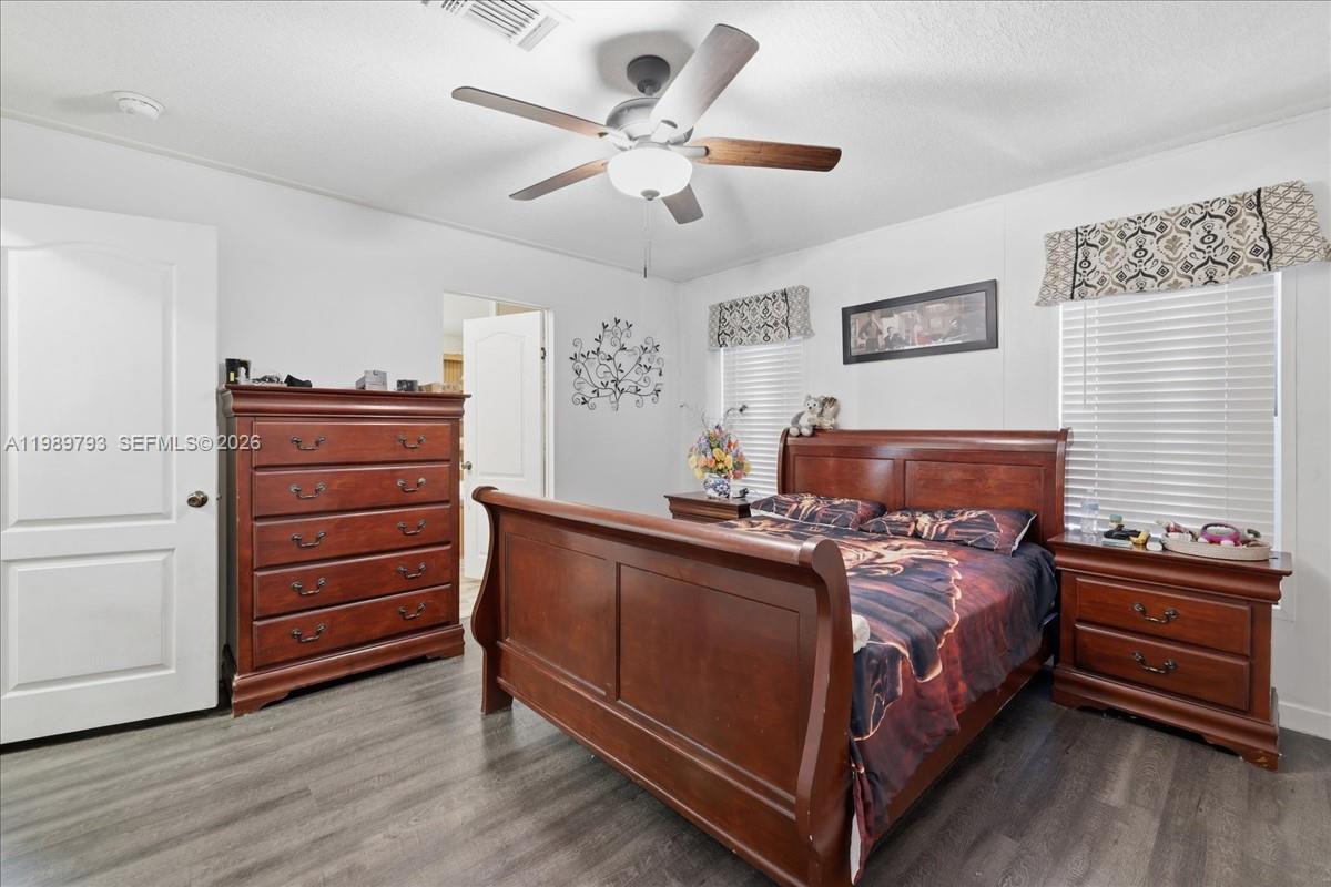 415 South Kennel Street Clewiston, FL 33440 - Photo 11 of 34 a bed room with a bed and a ceiling fan