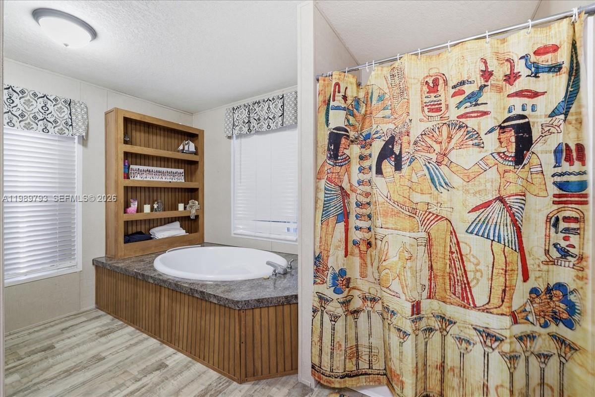 415 South Kennel Street Clewiston, FL 33440 - Photo 12 of 34 a bathroom with a sink a toilet and shower curtain