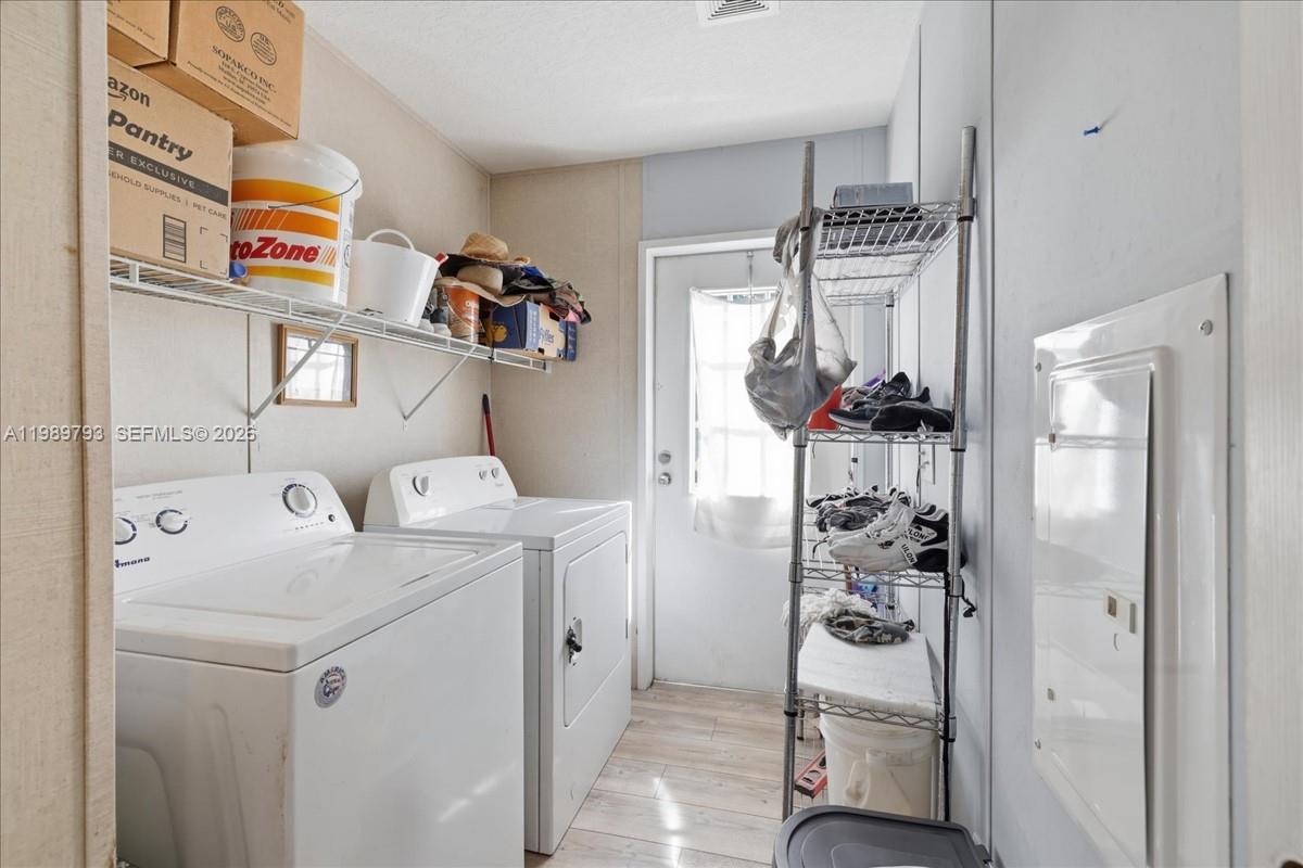 415 South Kennel Street Clewiston, FL 33440 - Photo 15 of 34 a utility room with dryer and washer