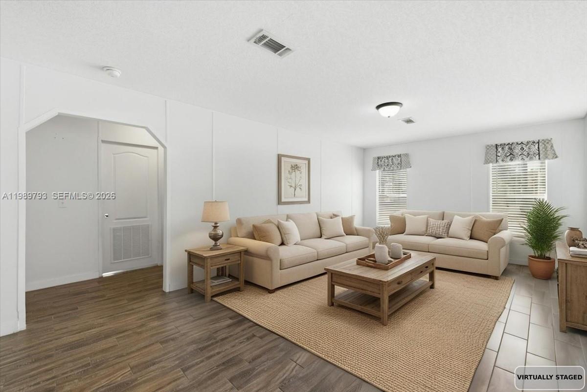 415 South Kennel Street Clewiston, FL 33440 - Photo 19 of 34 a living room with furniture and a wooden floor