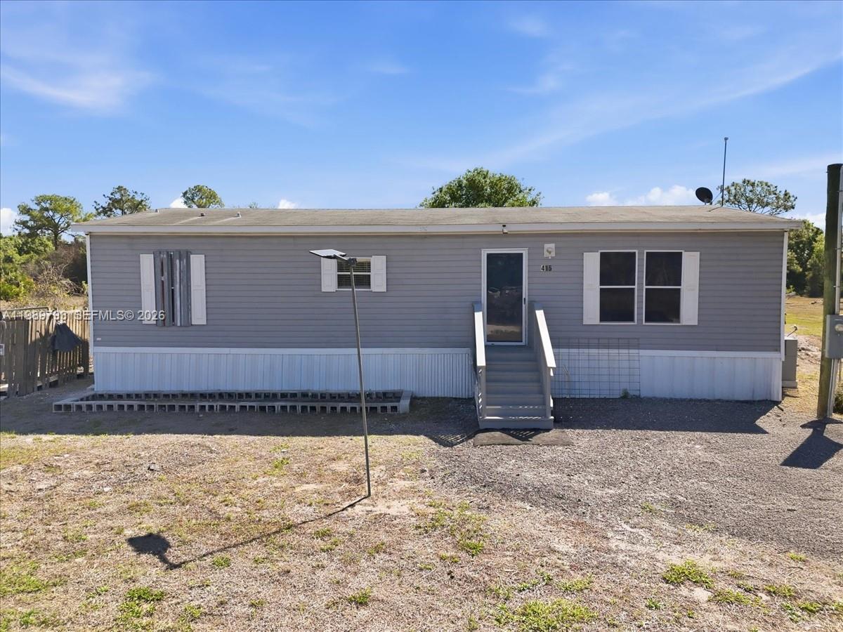 415 South Kennel Street Clewiston, FL 33440 - Photo 20 of 34 a front view of a house with a yard