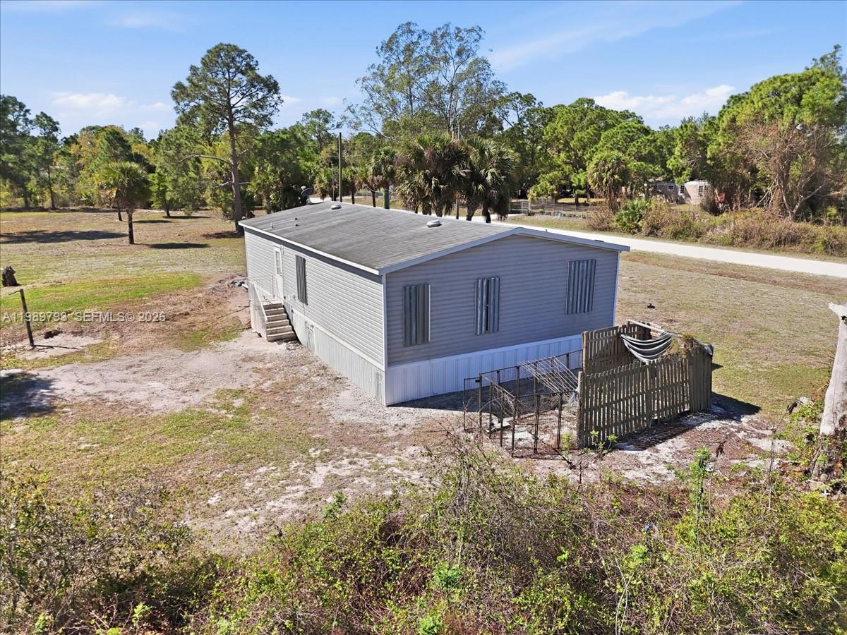 415 South Kennel Street Clewiston, FL 33440 - Photo 33 of 34 a aerial view of a house with a yard and lake view