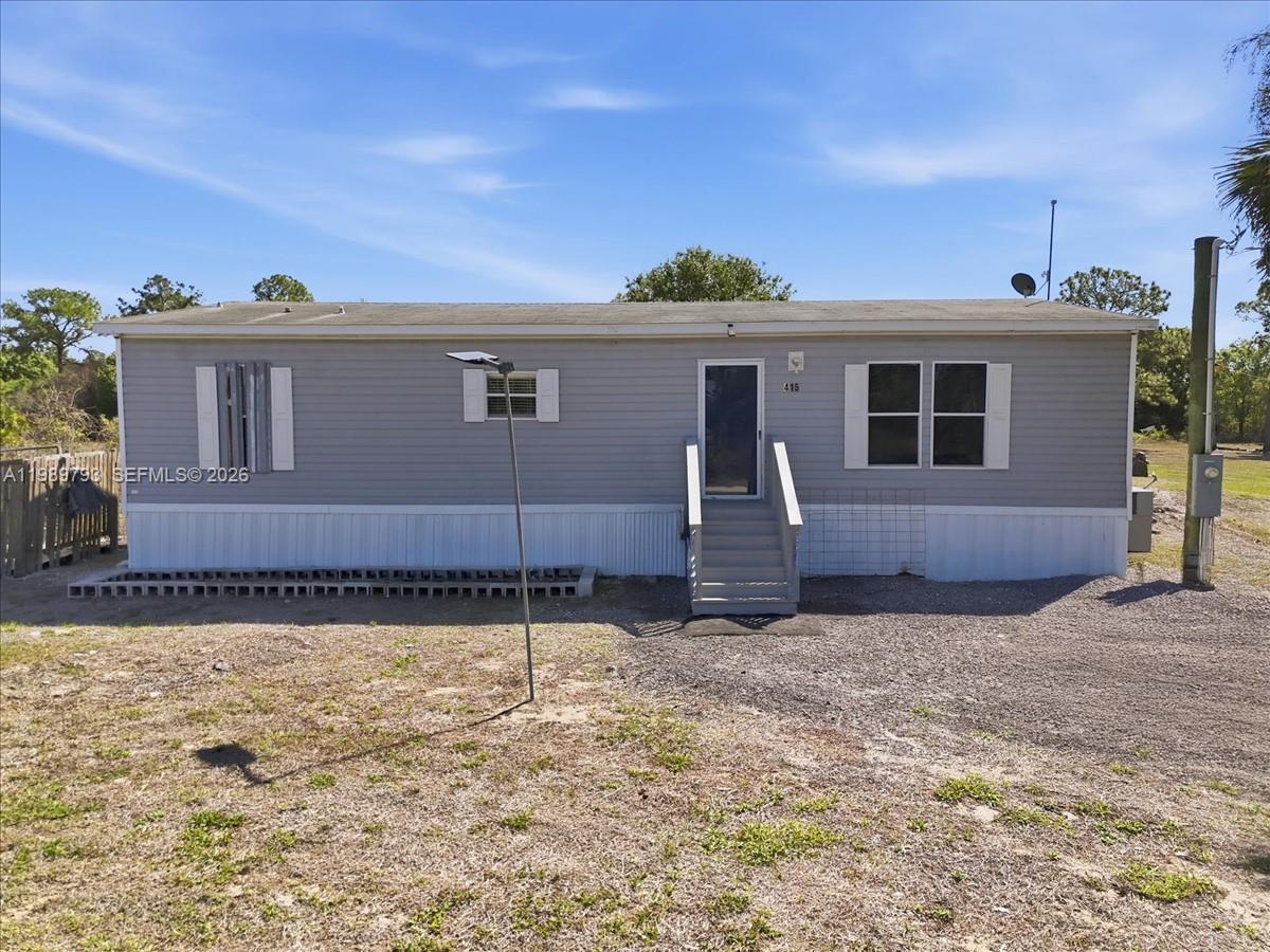 415 South Kennel Street Clewiston, FL 33440 - Photo 34 of 34 a view of a house with a backyard