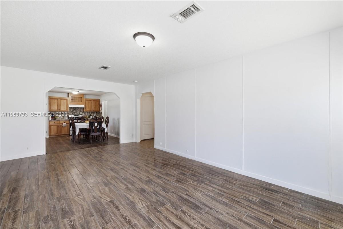 415 South Kennel Street Clewiston, FL 33440 - Photo 5 of 34 a view of a livingroom with wooden floor