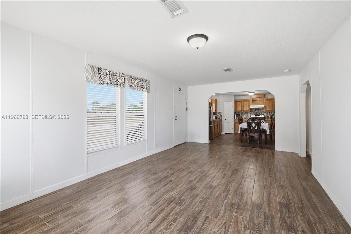 415 South Kennel Street Clewiston, FL 33440 - Photo 6 of 34 a view of livingroom with hardwood floor