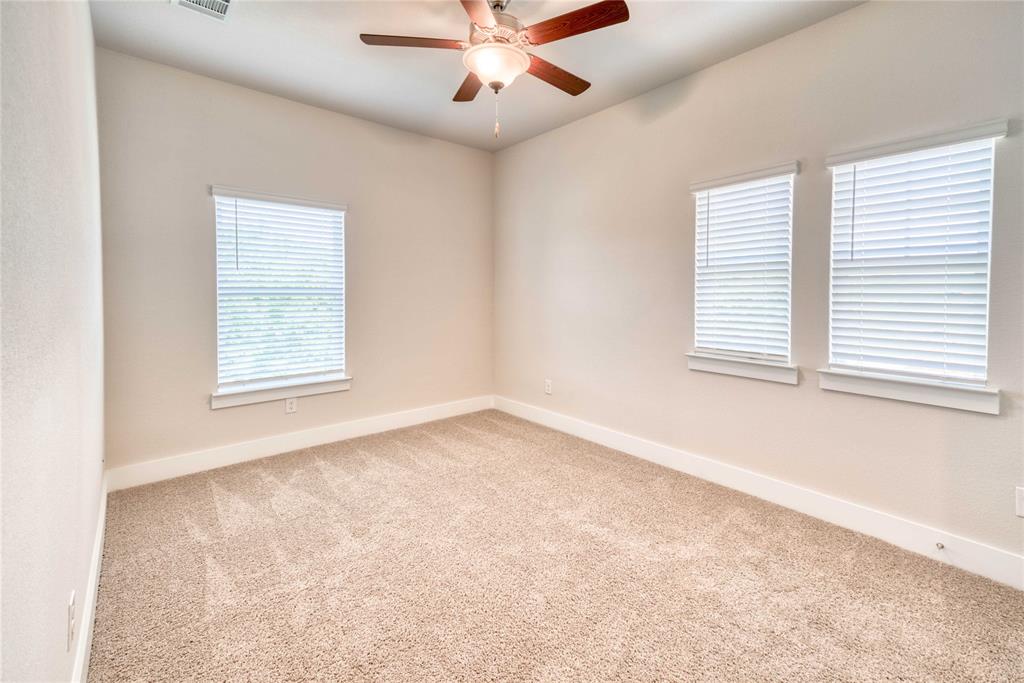 1407 Apricot Lane Gainesville, TX 76240 - Photo 6 of 9 an empty room with a window and a ceiling fan