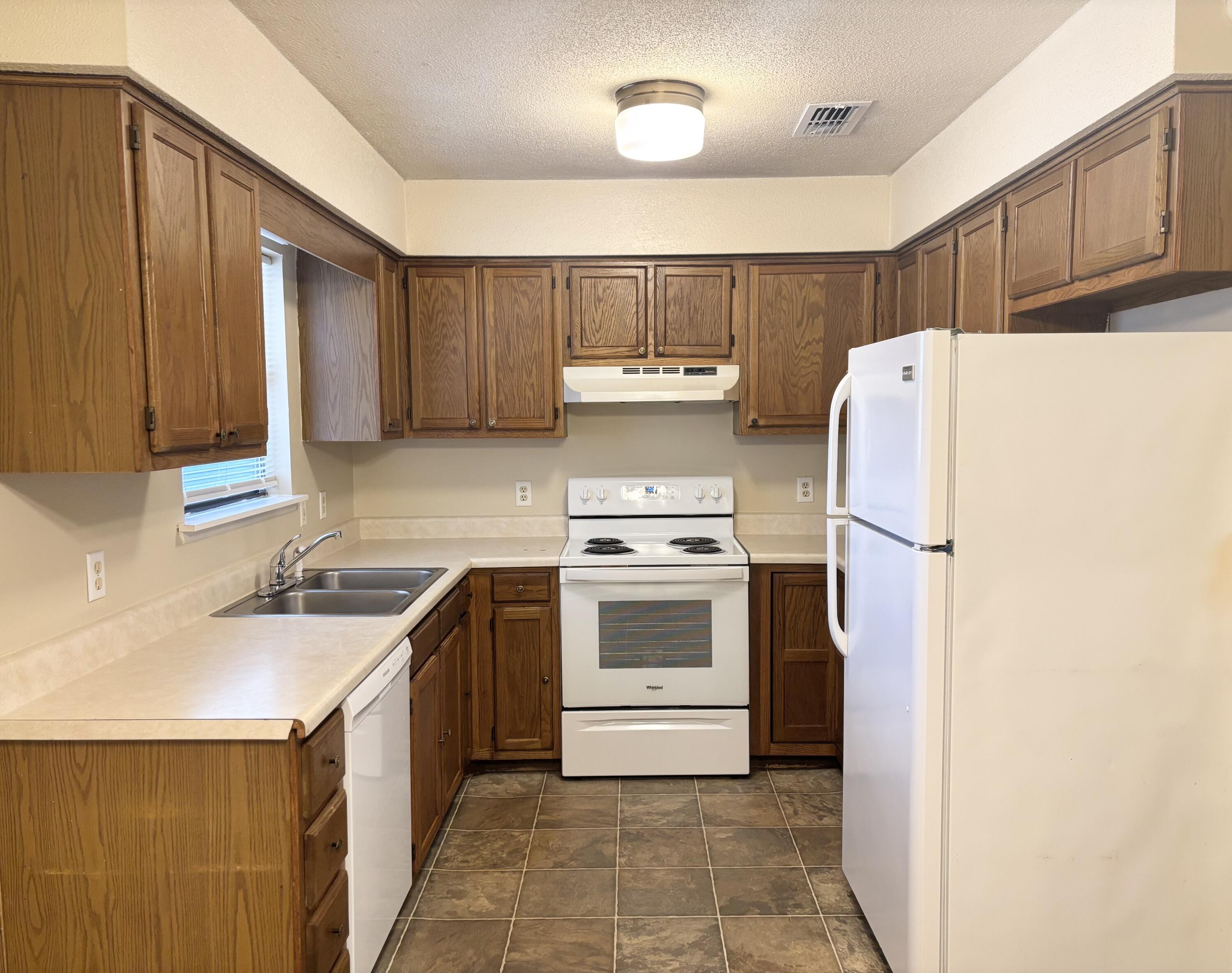 208 Squirrel Haven Road, Unit A Mary Esther, FL 32569 - Photo 2 of 13 a kitchen with a white stove top oven and refrigerator