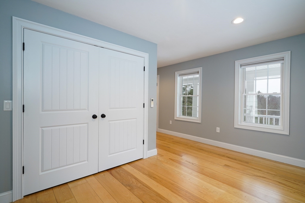 162 Fiskdale Road Brookfield, MA 01506 - Photo 12 of 42 a view of an empty room with wooden floor and a window