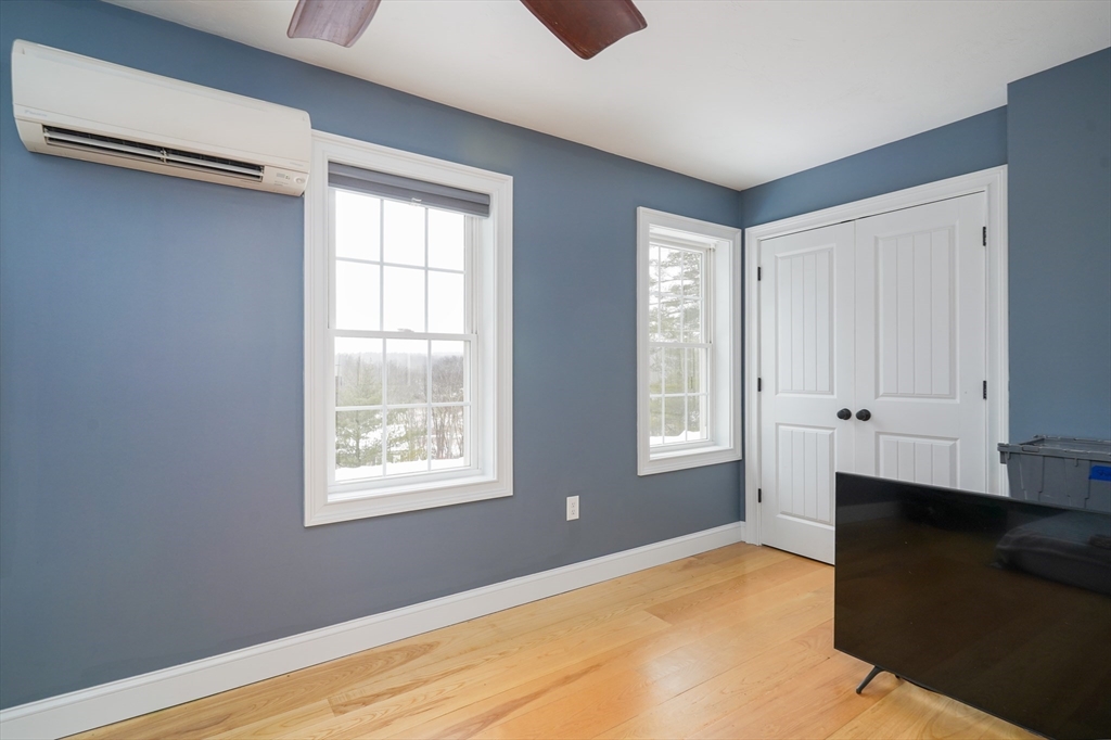 162 Fiskdale Road Brookfield, MA 01506 - Photo 19 of 42 a view of an empty room with wooden floor and a window