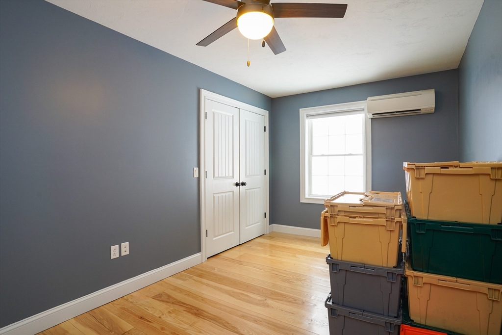 162 Fiskdale Road Brookfield, MA 01506 - Photo 21 of 42 a bedroom with a bed and a chandelier