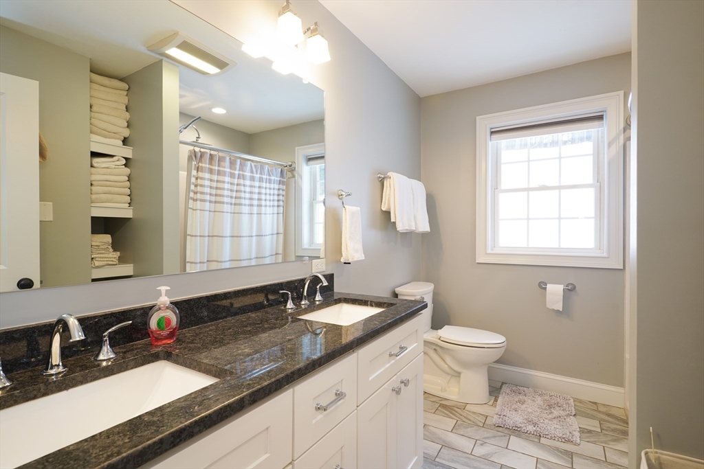 162 Fiskdale Road Brookfield, MA 01506 - Photo 23 of 42 a bathroom with a granite countertop sink a toilet and a mirror