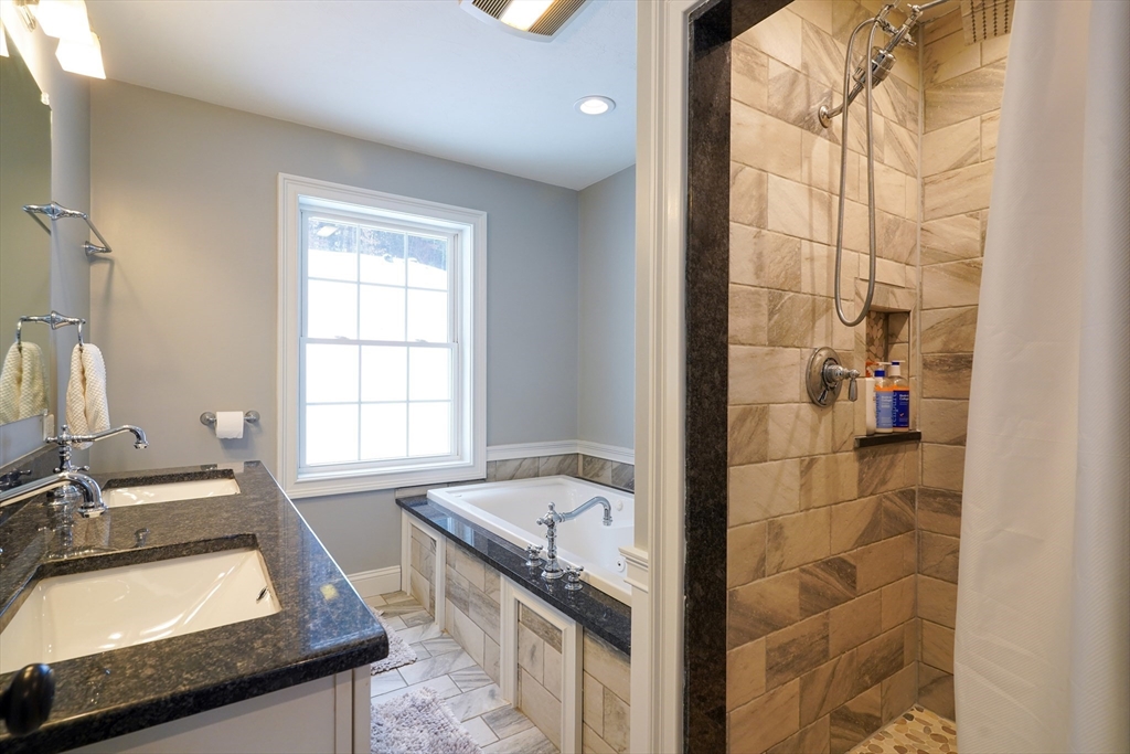 162 Fiskdale Road Brookfield, MA 01506 - Photo 29 of 42 a bathroom with a granite countertop sink a mirror and a bathtub