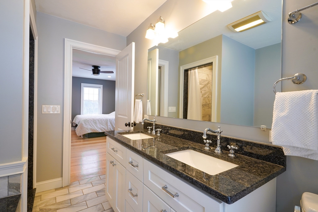 162 Fiskdale Road Brookfield, MA 01506 - Photo 30 of 42 a en suite bathroom with sinks granite countertop tub and a mirror