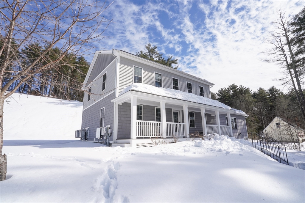162 Fiskdale Road Brookfield, MA 01506 - Photo 40 of 42 a front view of a house with a yard and large trees