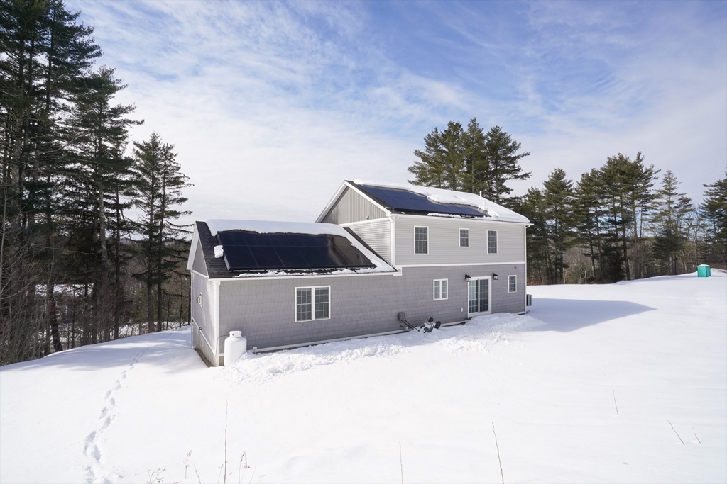 162 Fiskdale Road Brookfield, MA 01506 - Photo 42 of 42 a front view of a house with a yard covered in snow
