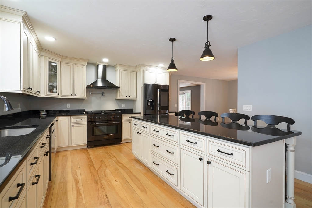 162 Fiskdale Road Brookfield, MA 01506 - Photo 8 of 42 a kitchen with granite countertop a sink a stove and cabinets