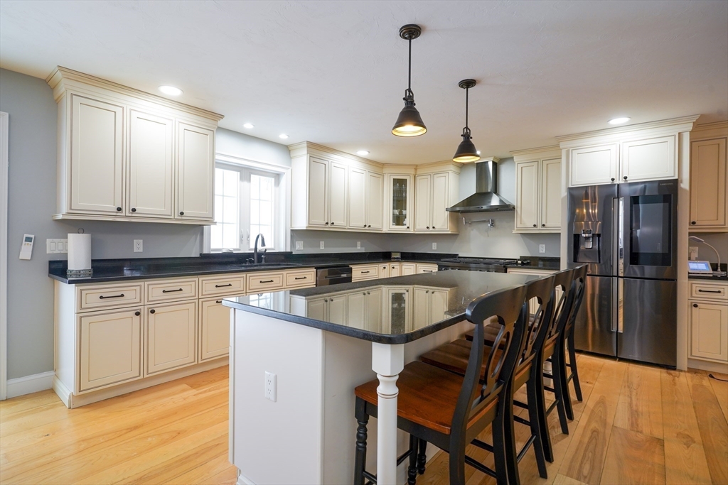 162 Fiskdale Road Brookfield, MA 01506 - Photo 9 of 42 a kitchen with stainless steel appliances granite countertop a sink a stove a refrigerator cabinets and chairs