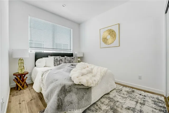 a bedroom with a bed and painting on the wall