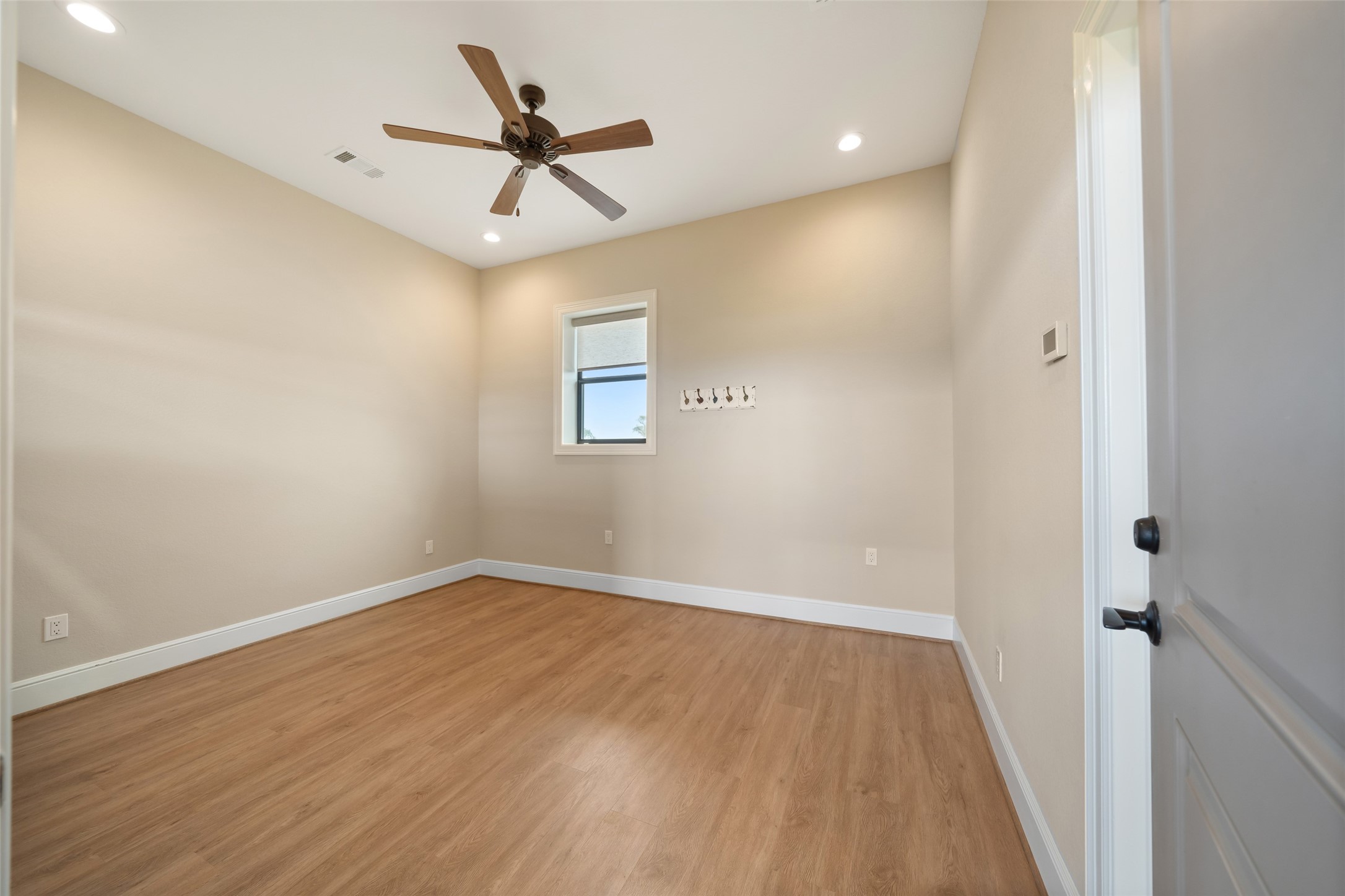 30163 High Spirit Ranch Road Hempstead, TX 77445 - Photo 44 of 49 wooden floor in an empty room with a window