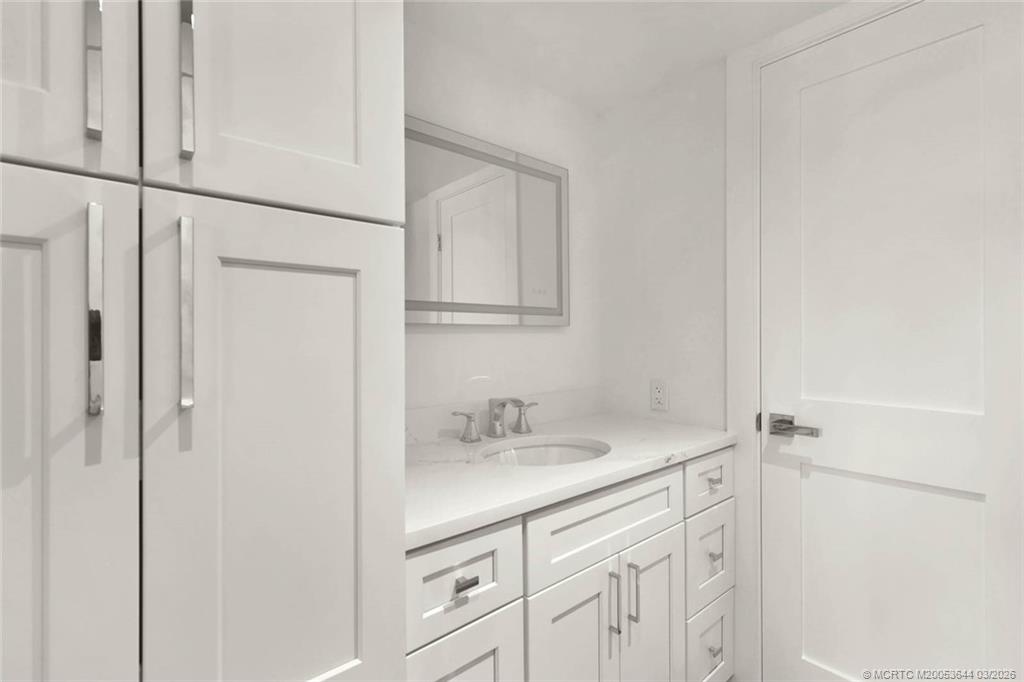 1950 Southwest Palm City Road, Unit 3201 Stuart, FL 34994 - Photo 17 of 27 a bathroom with a sink and vanity