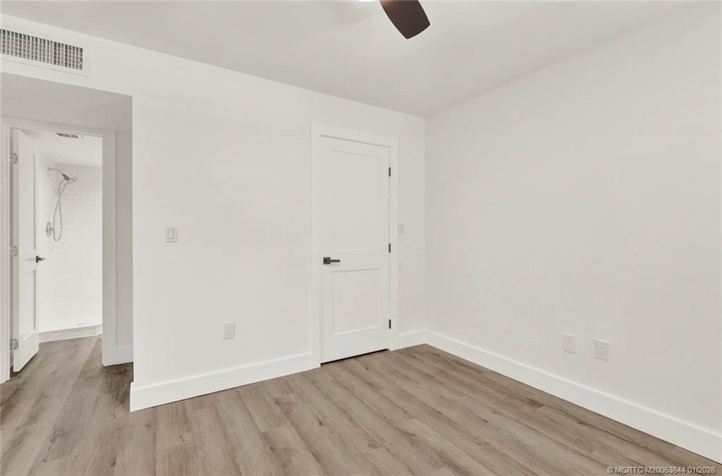 1950 Southwest Palm City Road, Unit 3201 Stuart, FL 34994 - Photo 17 of 28 a view of an empty room with wooden floor