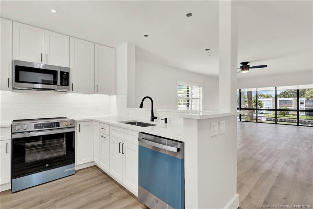 1950 Southwest Palm City Road, Unit 3201 Stuart, FL 34994 - Photo 3 of 28 a kitchen with granite countertop a stove and a sink