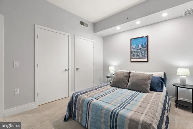 a bedroom with a bed and a night stand