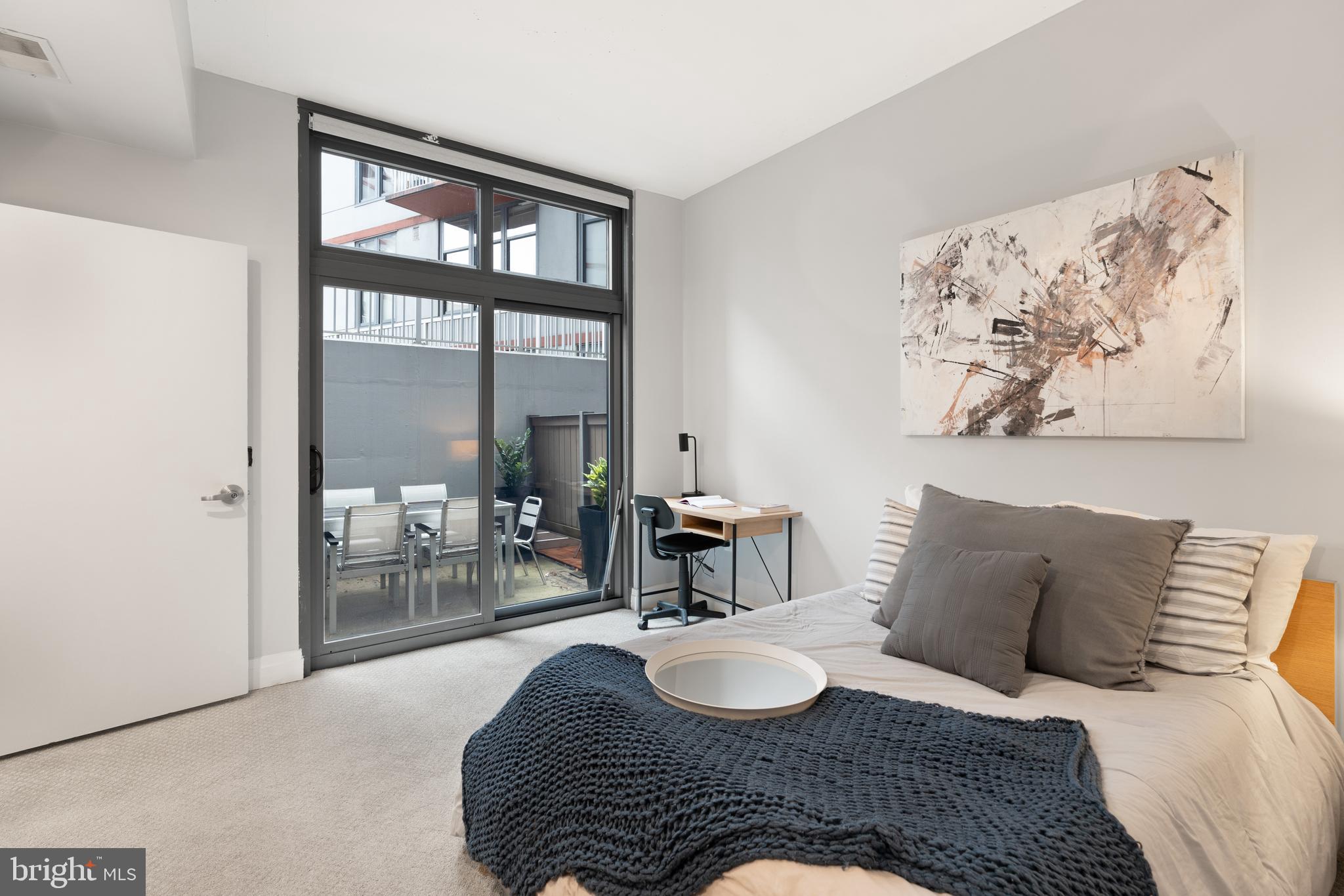2120 Vermont Avenue Northwest, Unit 17 Washington, DC 20001 - Photo 20 of 35 a bedroom with a bed and a table with painting on the wall