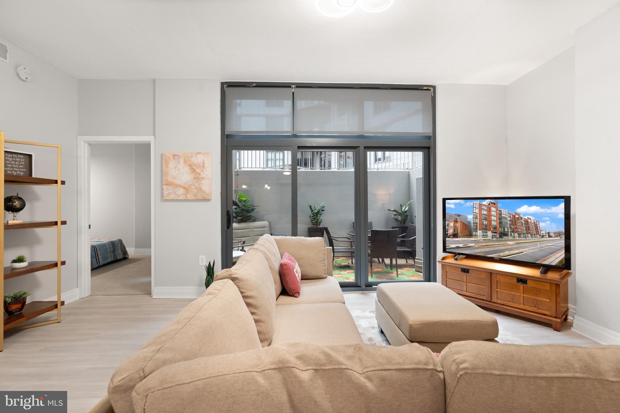 2120 Vermont Avenue Northwest, Unit 17 Washington, DC 20001 - Photo 2 of 35 a living room with furniture and a flat screen tv