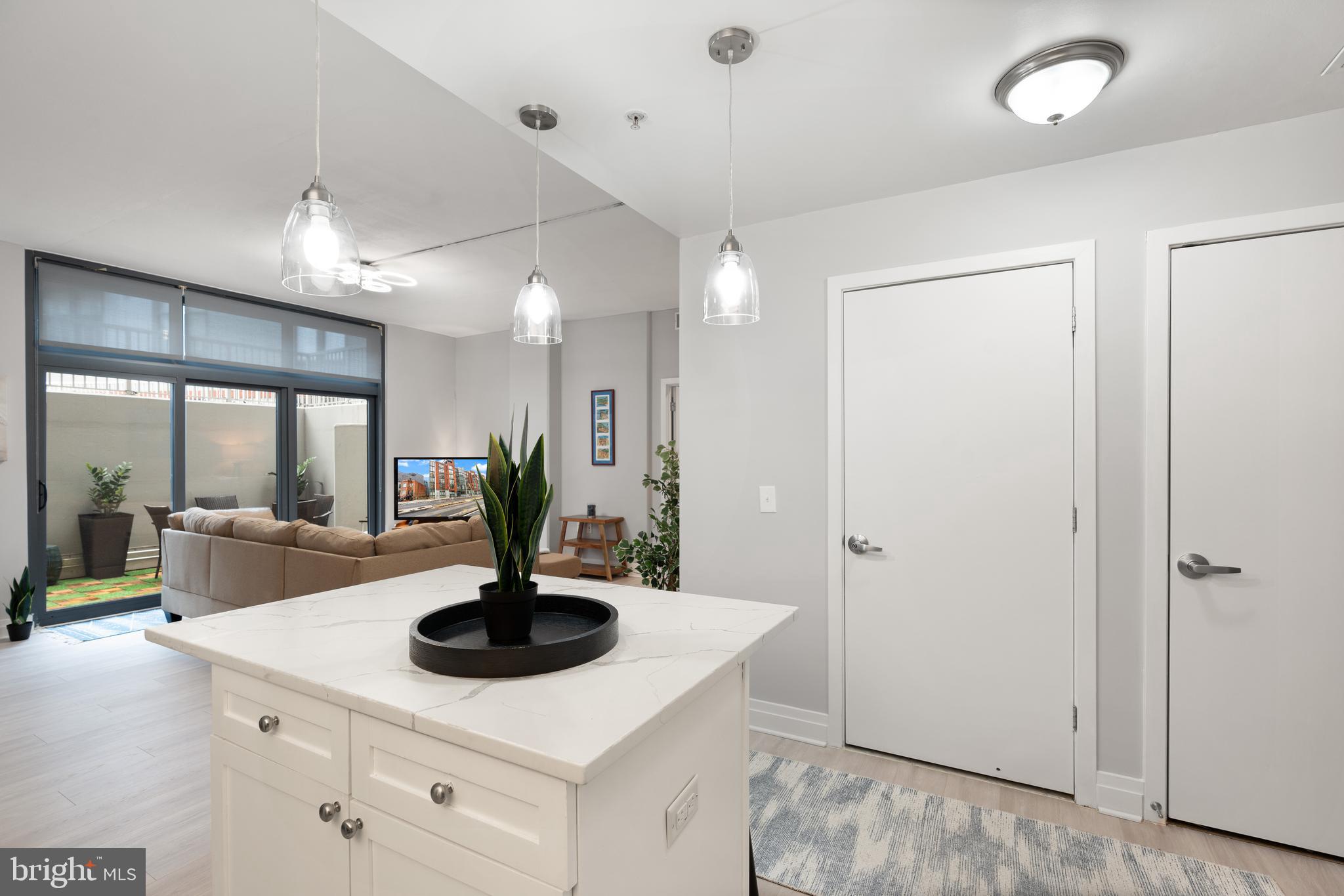 2120 Vermont Avenue Northwest, Unit 17 Washington, DC 20001 - Photo 6 of 35 a view of living room with granite countertop a sink a fireplace and cabinets
