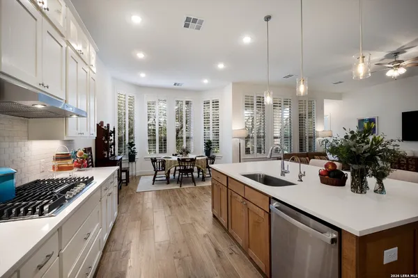 a kitchen with counter top space a sink appliances and cabinets
