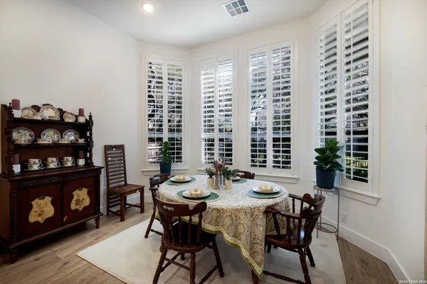 a view of a dining room with furniture and chandelier