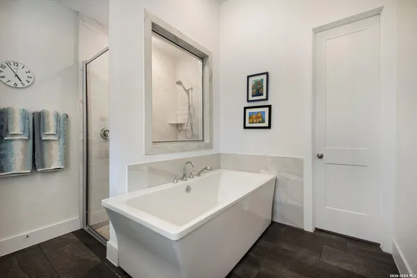 a white bath tub sitting next to a white sink