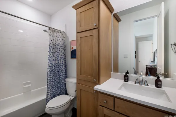a bathroom with a sink toilet a mirror and shower