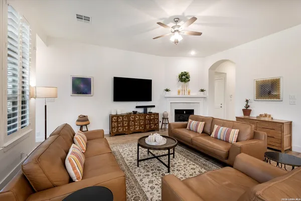 a living room with furniture a fireplace and a flat screen tv