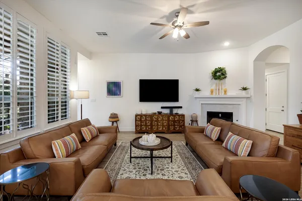 a living room with furniture a fireplace and a flat screen tv