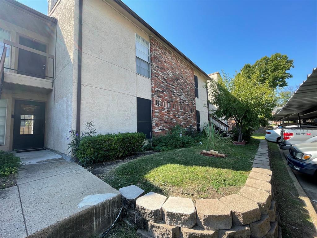 12480 Abrams Road, Unit 503 Dallas, TX 75243 - Photo 1 of 1 View of side of property with a lawn and a carport