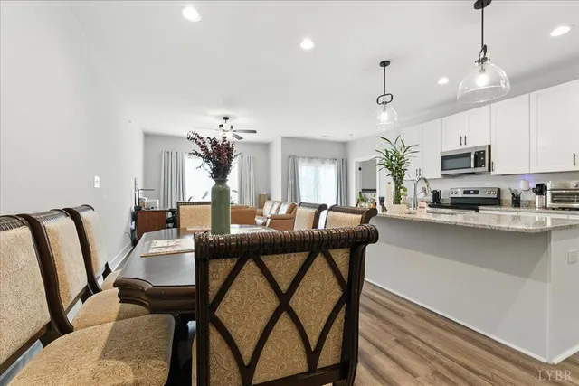 a view of a dining room with furniture and a chandelier