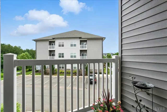a view of a house with a small yard and wooden fence