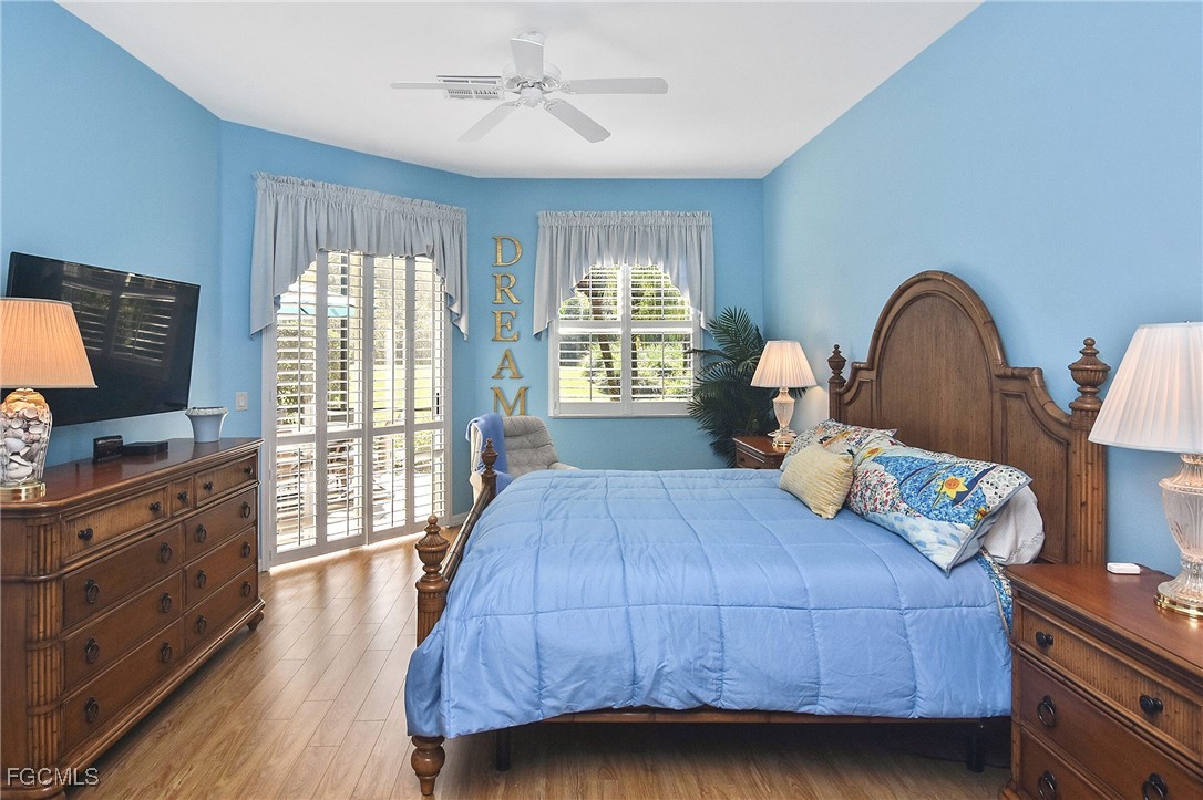 11131 Wine Palm Road Fort Myers, FL 33966 - Photo 26 of 48 a bedroom with a bed and wooden floor