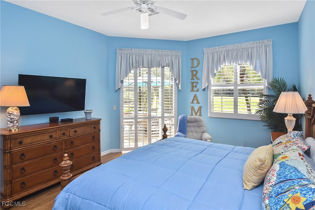 11131 Wine Palm Road Fort Myers, FL 33966 - Photo 27 of 48 a bedroom with a large bed and a flat tv screen on dresser