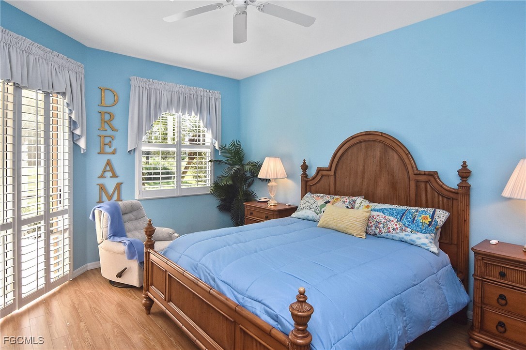 11131 Wine Palm Road Fort Myers, FL 33966 - Photo 28 of 48 a bedroom with a bed and wooden floor