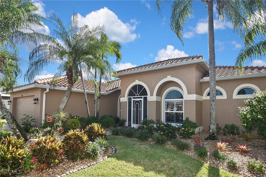 11131 Wine Palm Road Fort Myers, FL 33966 - Photo 3 of 48 a front view of a house with a garden