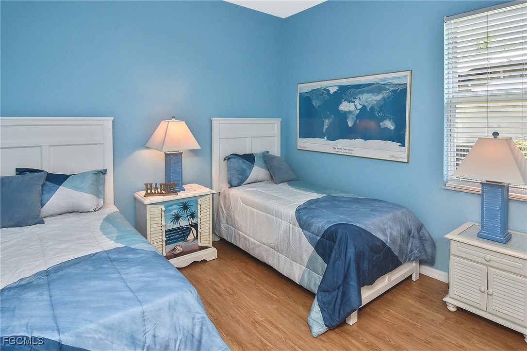 11131 Wine Palm Road Fort Myers, FL 33966 - Photo 32 of 48 a bedroom with a bed and a lamp on dresser