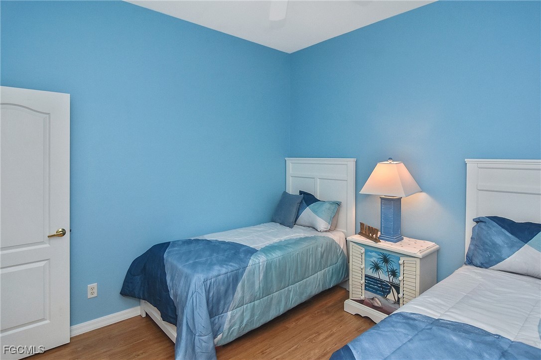 11131 Wine Palm Road Fort Myers, FL 33966 - Photo 33 of 48 a bedroom with a bed and a lamp on dresser